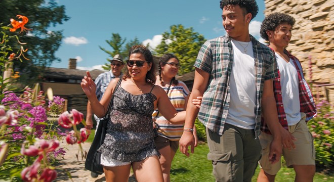 friends walking by colorful flowers