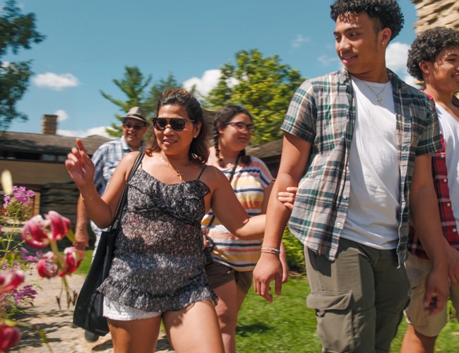 friends walking by colorful flowers
